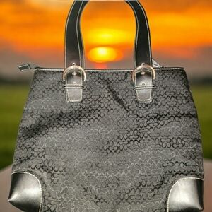 Coach Handbag with hanging leather tag. Zippered, back opened back pocket.